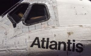 Space Shuttle Atlantis cockpit windows and upper crew cabin area. Details that illustrate the difference in construction of the TPS (Thermal Protection System) tiles, and TPS blankets are well-illustrated by the lighting in the exhibit hall.